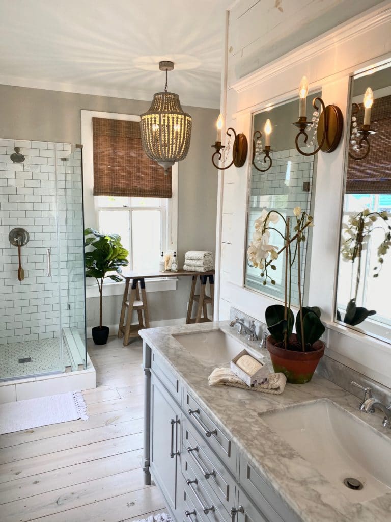 Interior design example of a well decorated bathroom with glass stand up shower and unique lighting.